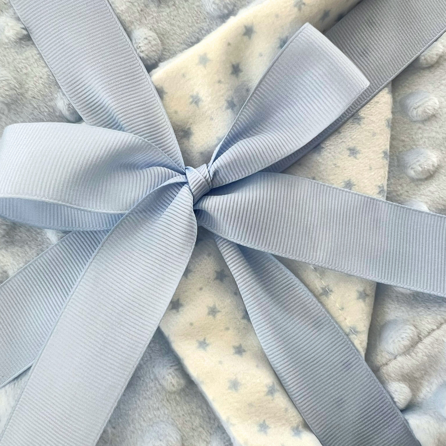 Manta reversible azul estrellitas